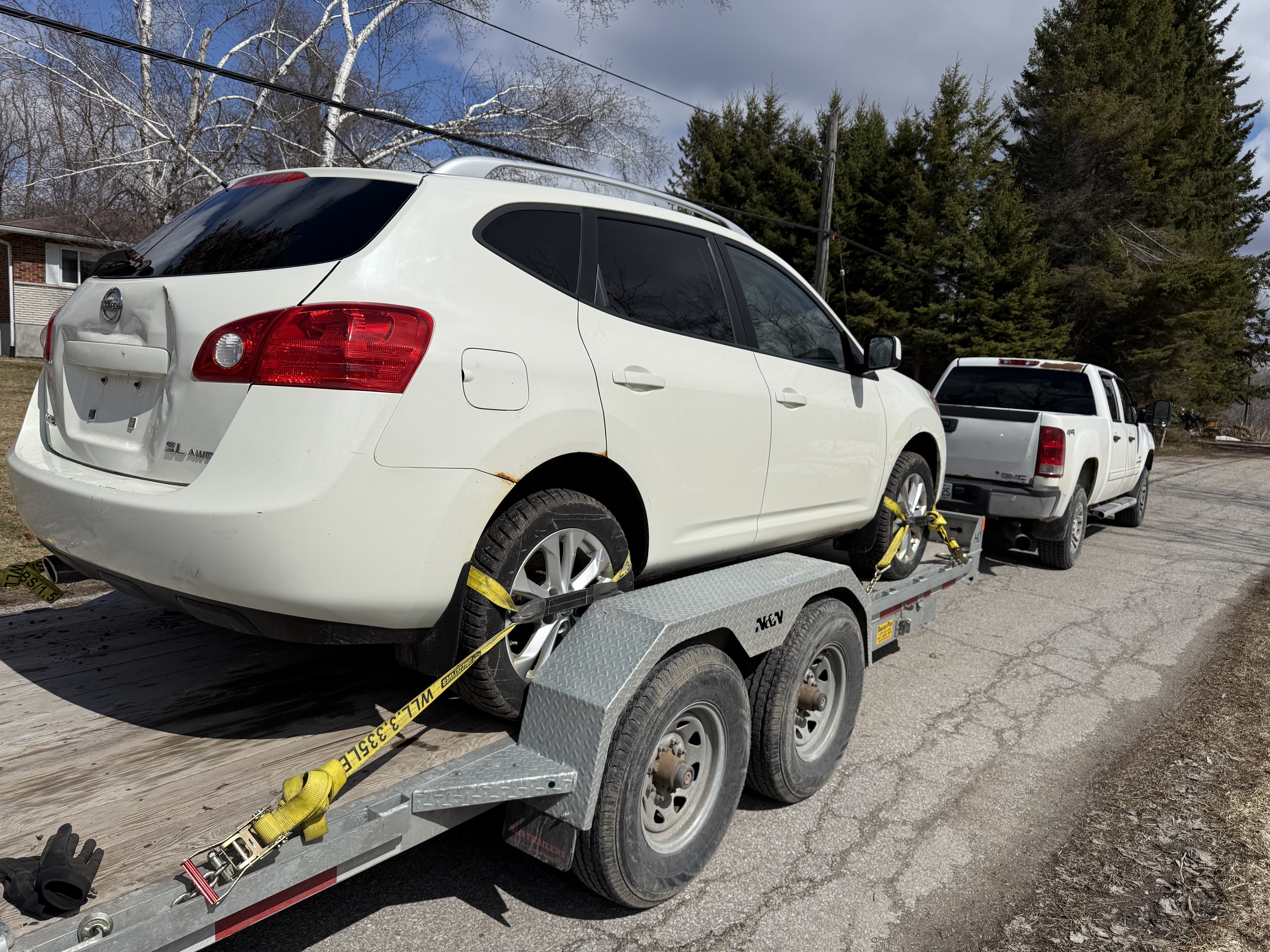 CanaDrive towing a Nissan Rogue for junk car removal